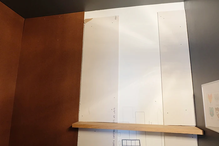 drywall, hardboard, and wood shelf installed