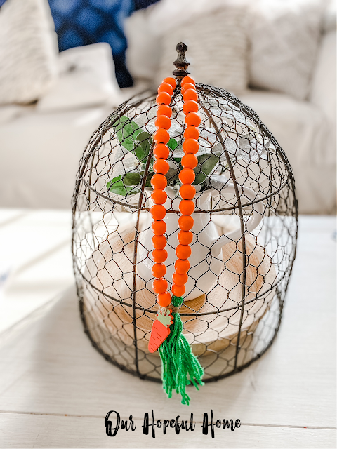 farmhouse chicken wire cloche with orange wood bead Easter garland