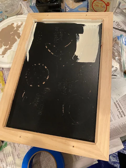 Photo of a tray being painted with off white paint.