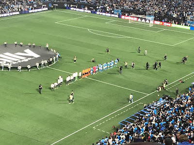 Both teams lined up on the sideline being introduced.