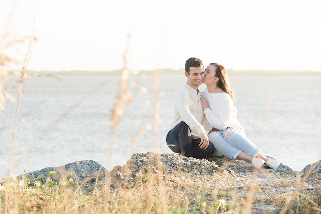 couple sitting on the rocks kissing