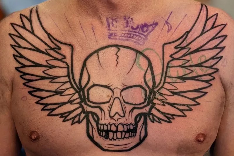 Skull with wings, chest tattoo for men.