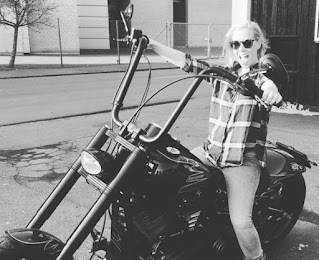 Stine Gyldenbrand posing for a picture while sitting in a bike