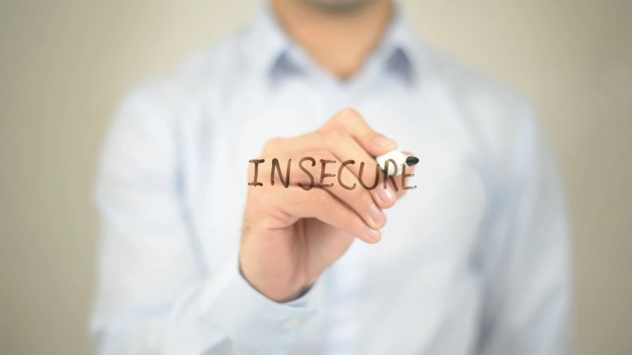 insecure, man writing on transparent screen.