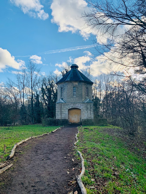 Pigeon house at Painswick Rococo Gardens with blue sky and clouds behind