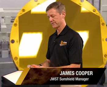 James Cooper, JWST manager showed a sample of the mirror made of Beryllium, seen in the background. NASA/ESA, 25 December 2021.