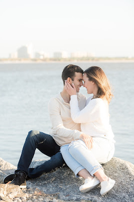 couple sitting on the rocks smiling