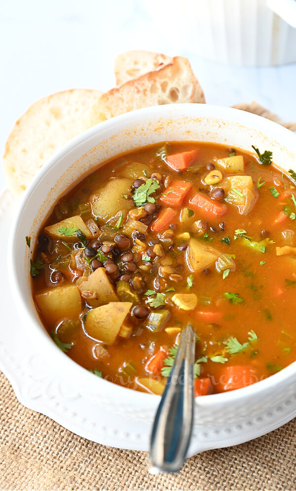 a closer look at a white bowl with vegetarian lentil soup