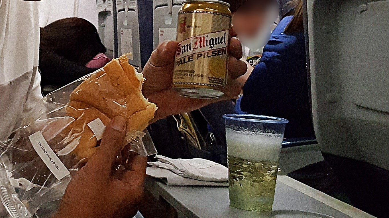 ham and cheese sandwich and san miguel beer in can bouoght on board a cebu pacific flight from cebu to singapore