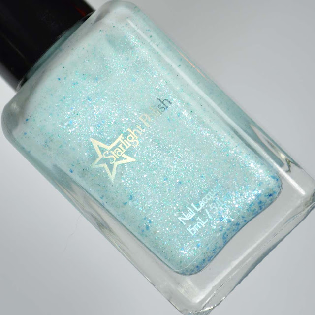 white crelly nail polish with blue flakies and glitter in a bottle