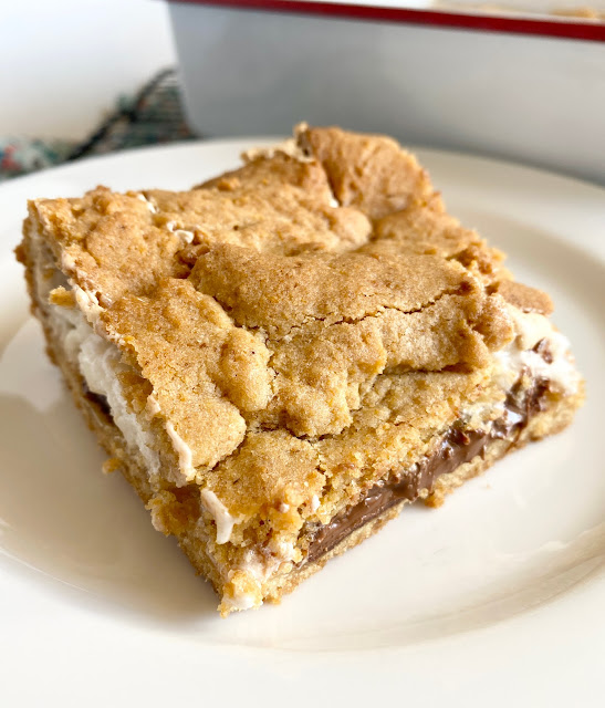 Piece of S'more Cookie Bar on a white plate.