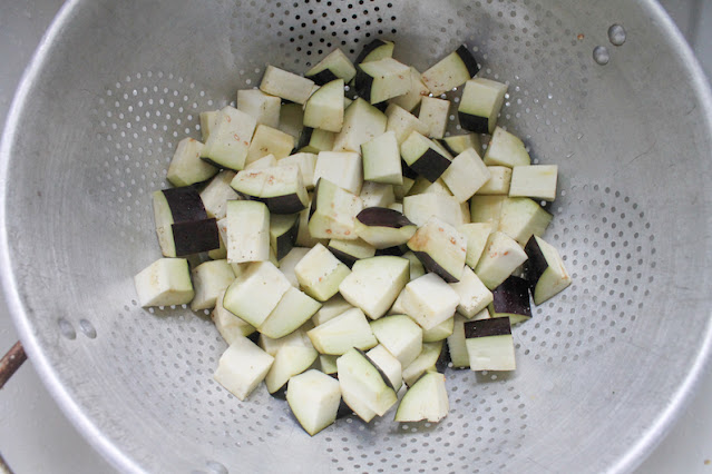 The eggplant cubes draining