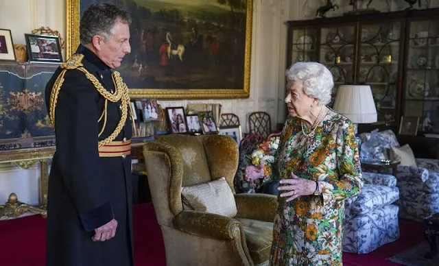 Queen Elizabeth wore a colorful floral dress and wearing a string of pearls at official engagement