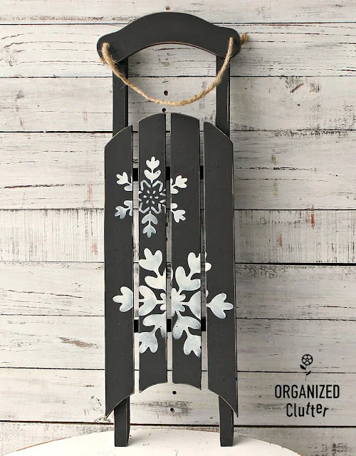 Photo of an upcycled sled with stenciled snowflakes.