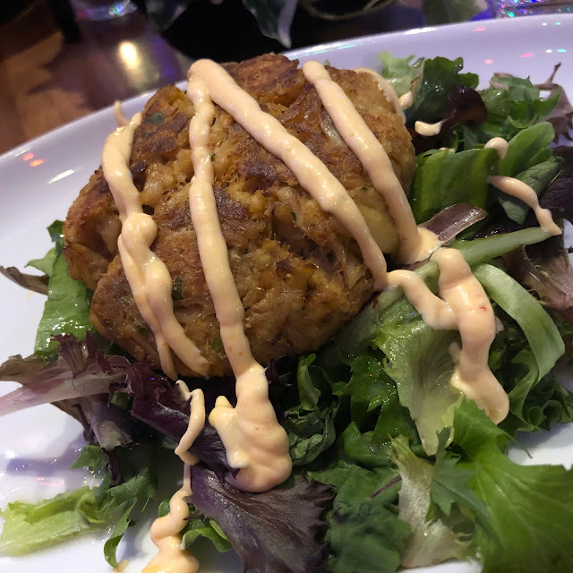 Hey Nonny's Crab Cake comes atop a bed of greens.