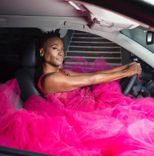 Billy Porter posing for picture while sitting inside the car