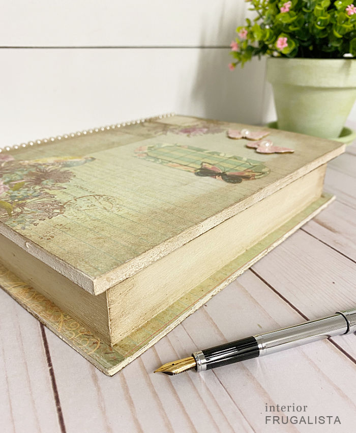 How to upcycle an unfinished wooden book box with pretty decoupage vintage-style scrapbook paper and dollar store supplies and give it an aged patina.