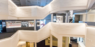 Interior stairways and view of exhibitions at Sydney Jewish Museum, with names of Jewish people written on the stairways