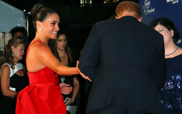 Meghan Markle wore a red gown by Carolina Herrera and shoes by Giuseppe Zanotti. Birks snowflake snowstorm diamond earrings
