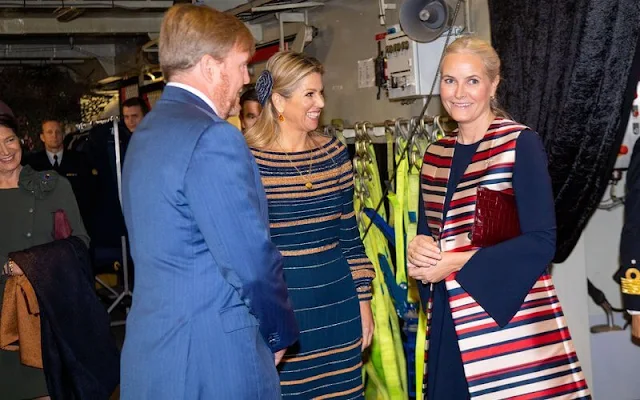 Crown Princess Mette Marit wore a satin stripe sleeveless trench coat by Tome. Queen Maxima wore a navy and beige dress by Jan Taminiau