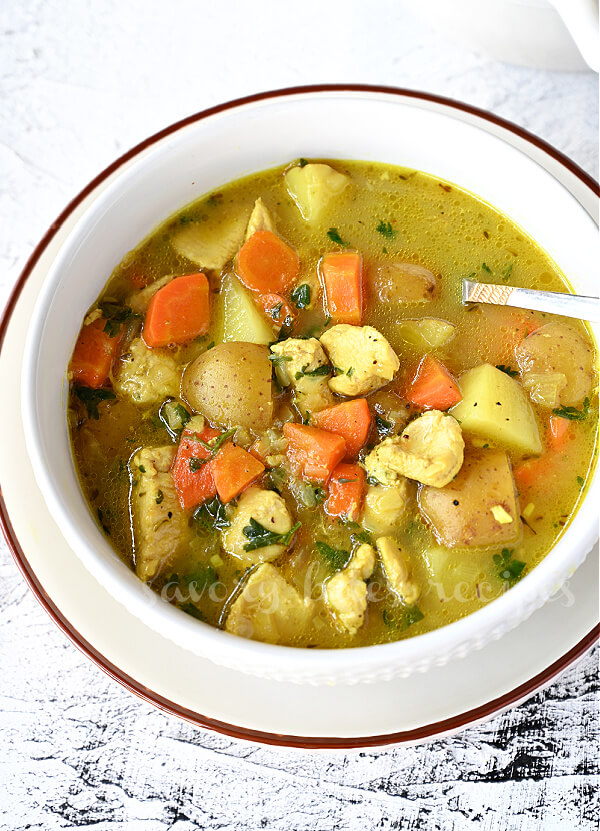 top view of  white bowl with thick hearty chicken stew