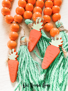 orange wood bead garland with wooden carrots and green jute tassels