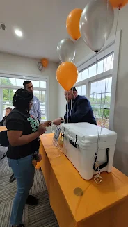 Resident entering Yeti cooler raffle displayed on table