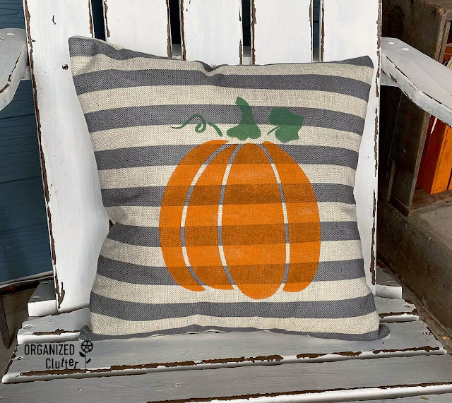 Photo of a stenciled pumpkin pillow.