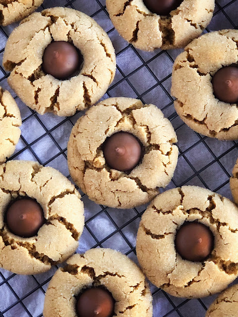 peanut butter cookies with Hershey's kisses on a cooling rack