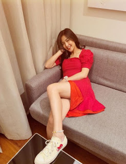 Charlie Dizon posing for a picture while sitting in a sofa
