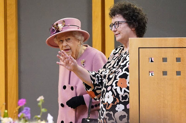 Queen Elizabeth wore a Stewart Parvin outfit. Rachel Trevor-Morgan hat. Welsh Daffodil brooch. Fiona Clare coat
