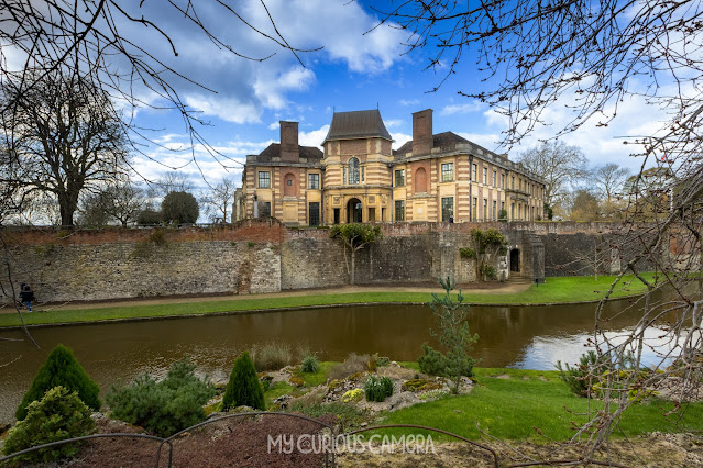 Eltham Palace showing the moat and grass