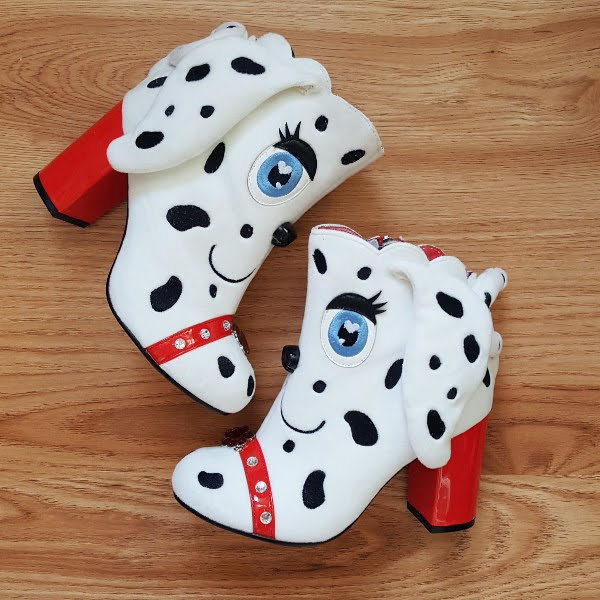 white fur Dalmatian ankle boots on wooden floor