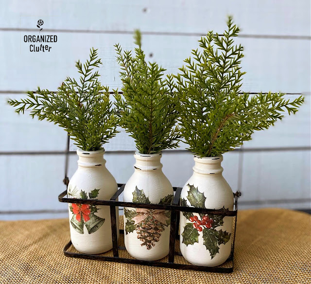 Photo of chalk painted bottles with decor transfers.