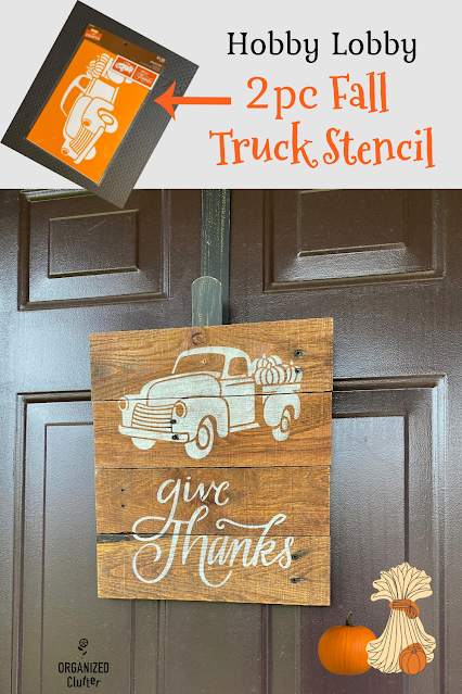 Photo of a Goodwill rustic photo holder stenciled as a fall truck front door sign.