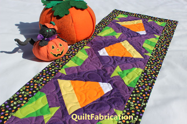 candy corn and green wrapped candies on purple