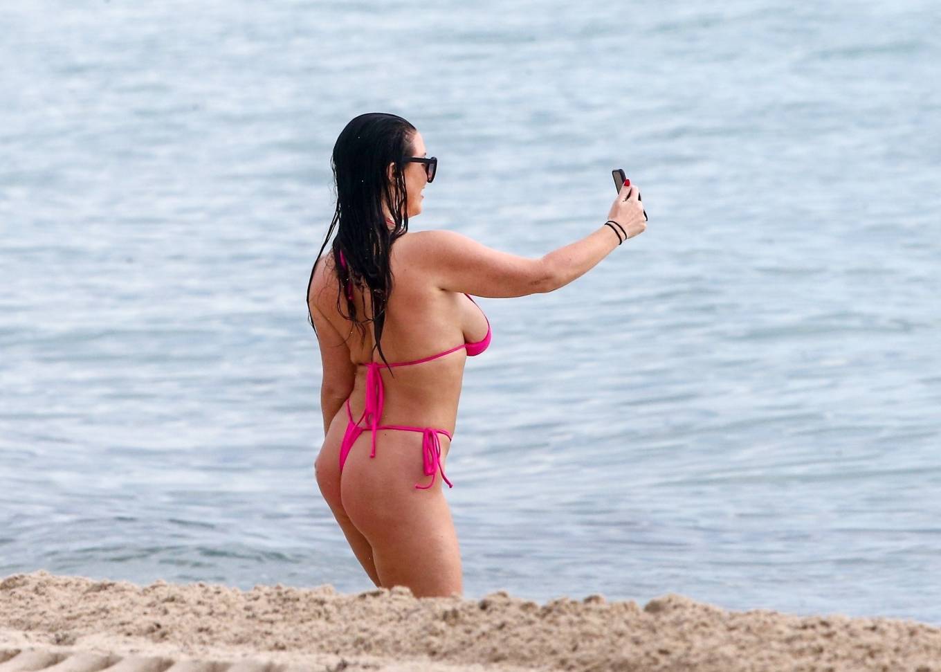 Angela White showcase her ample assets in a Pink bikini in Miami Beach