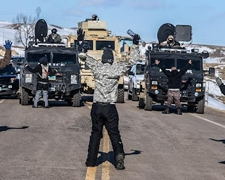 Water protectors use their bodies to keep law enforcement vehicles from ascending on Last Child Camp, February 1, 2017