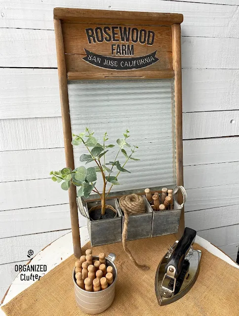 Photo of a vintage washboard upcycled with Weathered Wood Accelerator, a decor transfer, wax and a metal container.