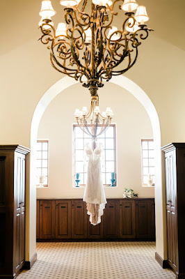 wedding dress hanging on chandelier