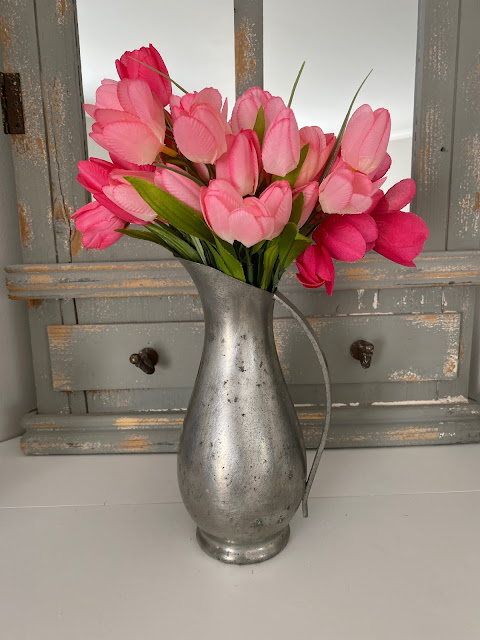 pewter pitcher filled with pink tulips spring vase display