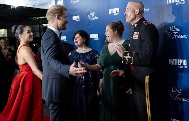 Meghan Markle wore a red gown by Carolina Herrera and shoes by Giuseppe Zanotti. Birks snowflake snowstorm diamond earrings