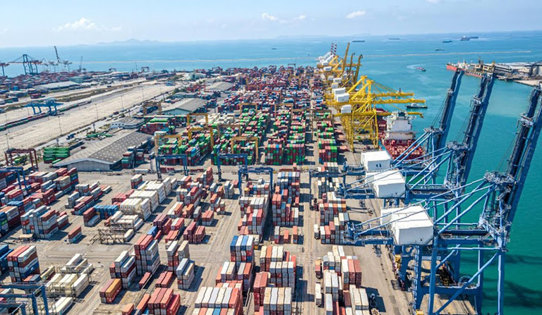 Cranes hoist freight containers: Thailand scrambles to survive a protectionist world.