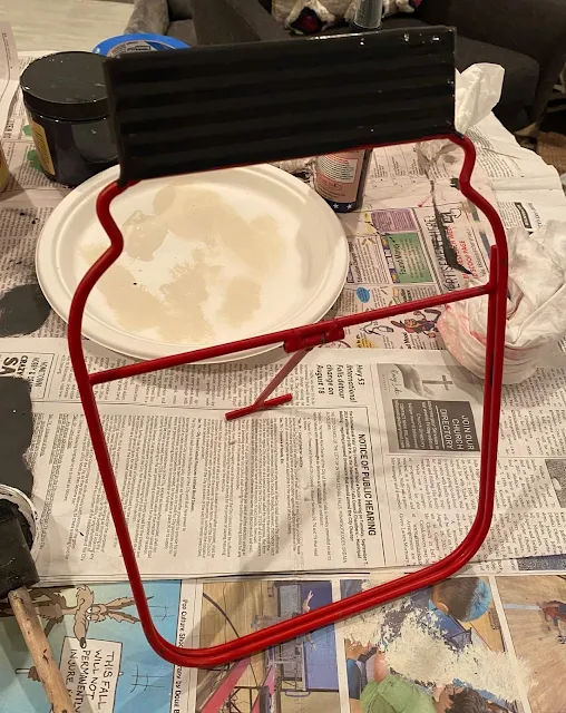 Photo of a metal jar shaped chalkboard easel.