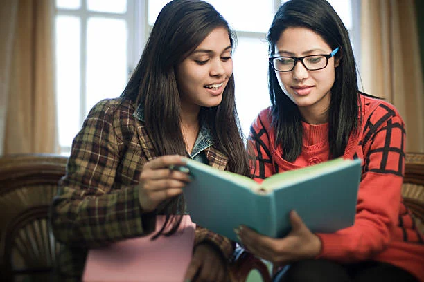 Two girl reading a book