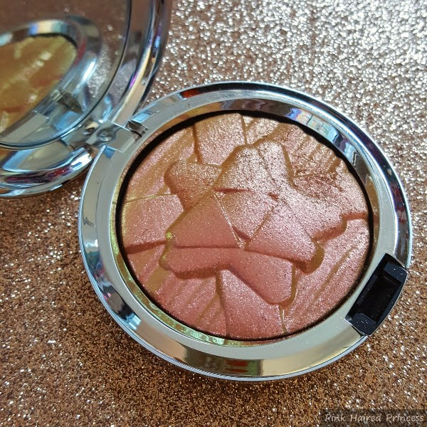 open highlighting compact with shiny embossed bow design on powder