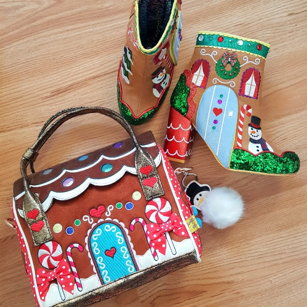 gingerbread house themed ankle boots and bag on wooden floor