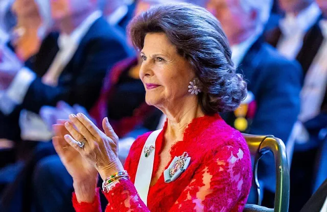 Royal Swedish Academy of Engineering Sciences. Queen Silvia wore a red lace dress. Van Cleef and Arpels flower earrings