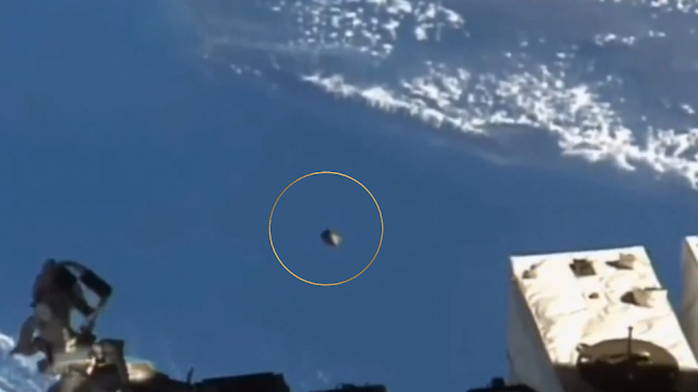 Silver metallic UFO underneath the ISS.