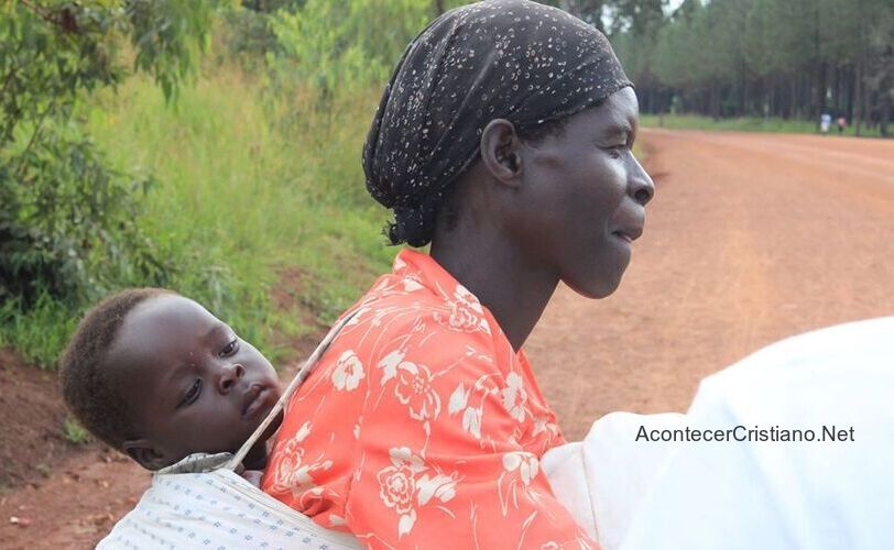 Mujer de Uganda cargando a su hijo en la espalda